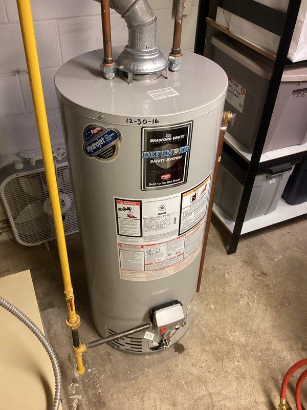 Performed scheduled maintenance on Bradford White tanked water heater (installed 12/30/16). Inspected all connections, noting minor mineral deposits on copper pipes and valve assembly. System functioning properly with no active leaks detected. Confirmed proper operation of the Defender Safety System and verified gas line connection integrity.