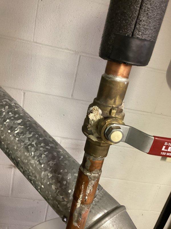 Performed scheduled maintenance on Bradford White tanked water heater (installed 12/30/16). Inspected all connections, noting minor mineral deposits on copper pipes and valve assembly. System functioning properly with no active leaks detected. Confirmed proper operation of the Defender Safety System and verified gas line connection integrity.