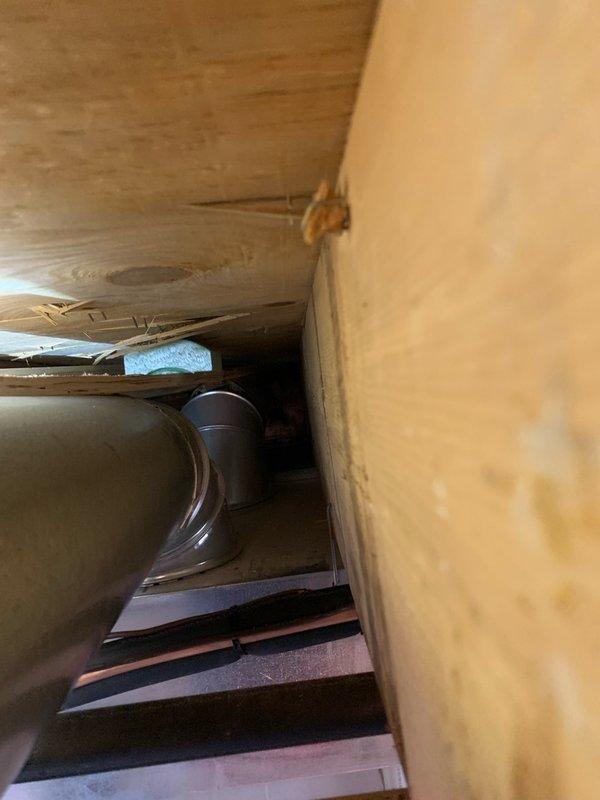 Performed inspection of customer-reported uneven heating issue and disconnected piping in crawlspace. Identified water damage on wooden ceiling joists near HVAC ductwork. Reconnected loose duct connection and verified system operation to resolve uneven heating distribution to upper floor.