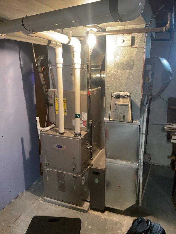 Performed scheduled heating tune-up on Carrier furnace system located in basement utility room. Inspected all components including ductwork connections, PVC venting pipes, and electrical connections for proper operation. System was found to be functioning correctly with no issues requiring repair.