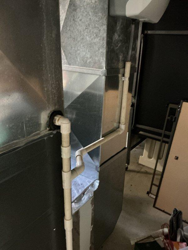 Resolved water leak at PVC elbow joint connecting humidifier drain line to furnace. Inspected entire condensate drainage system and secured connection to prevent further leakage. System now operating properly with no moisture issues.