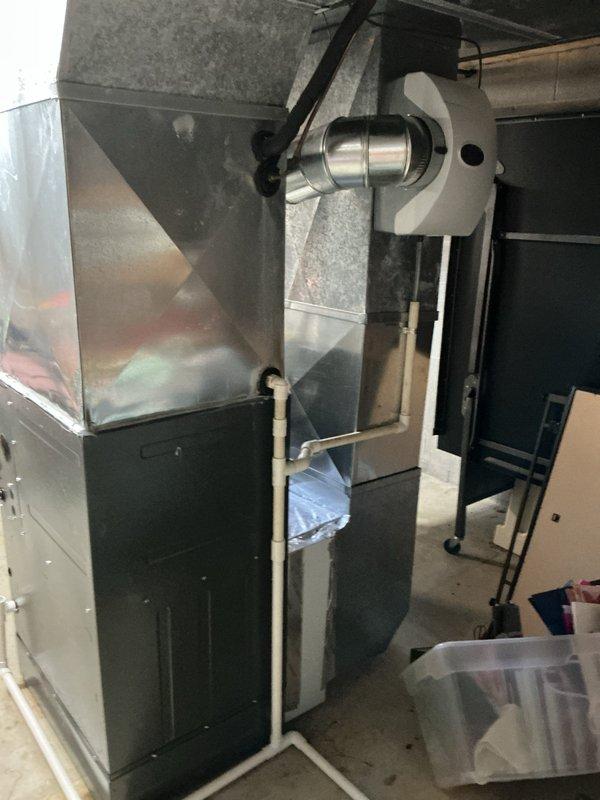 Resolved water leak at PVC elbow joint connecting humidifier drain line to furnace. Inspected entire condensate drainage system and secured connection to prevent further leakage. System now operating properly with no moisture issues.