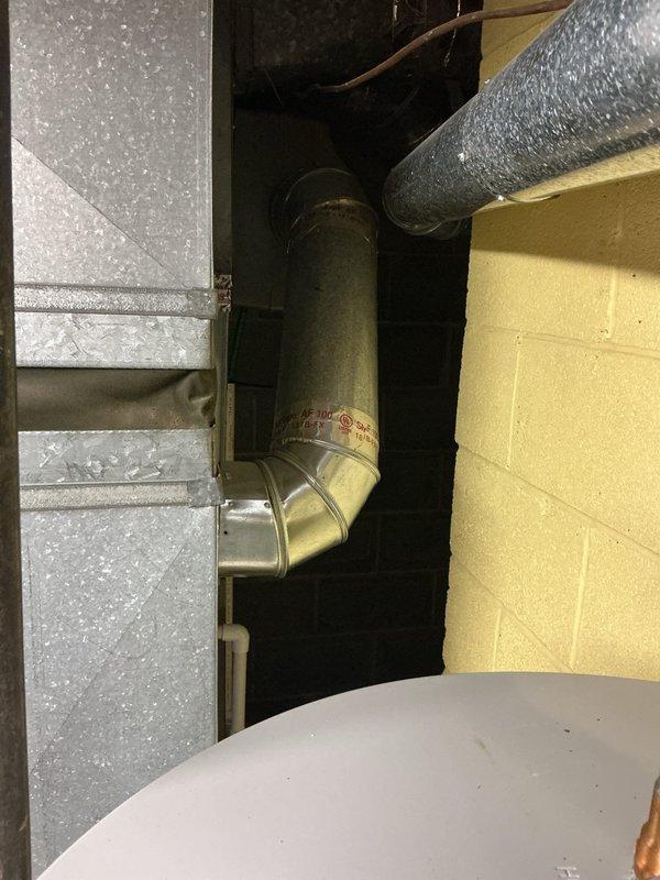 Inspected humidifier leakage issue on HVAC system located in utility room. Performed diagnostic assessment of the Bradford White Defender system and associated ductwork connections. Documented condition of metal vent piping and water heater integration for comprehensive evaluation.