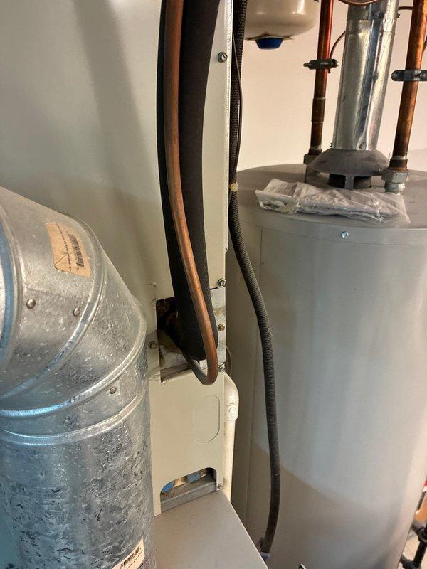 Conducted comprehensive assessment of existing HVAC system showing end-of-life conditions with complete heat failure. Evaluated current installation configuration including water heater connections and ductwork placement for replacement feasibility. Documented plumbing components and shut-off valve positioning to ensure proper system integration in replacement proposal.