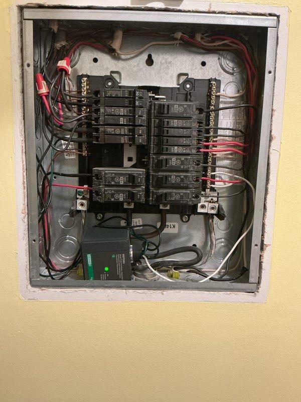Performed comprehensive electrical inspection of main panel, identifying properly organized but densely arranged wiring with no visible damage. Installed surge protector in electrical panel to provide enhanced protection against power surges. Verified proper electrical connection and outlet functionality for laundry appliances.