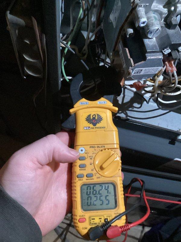 Performed scheduled heating maintenance service on system. Conducted electrical diagnostics using UEi Phoenix multimeter, measuring amperage draw (0.255A) and voltage (16.24V) on blower motor. Inspected internal wiring connections and motor assembly, confirming all components were properly secured and operational.