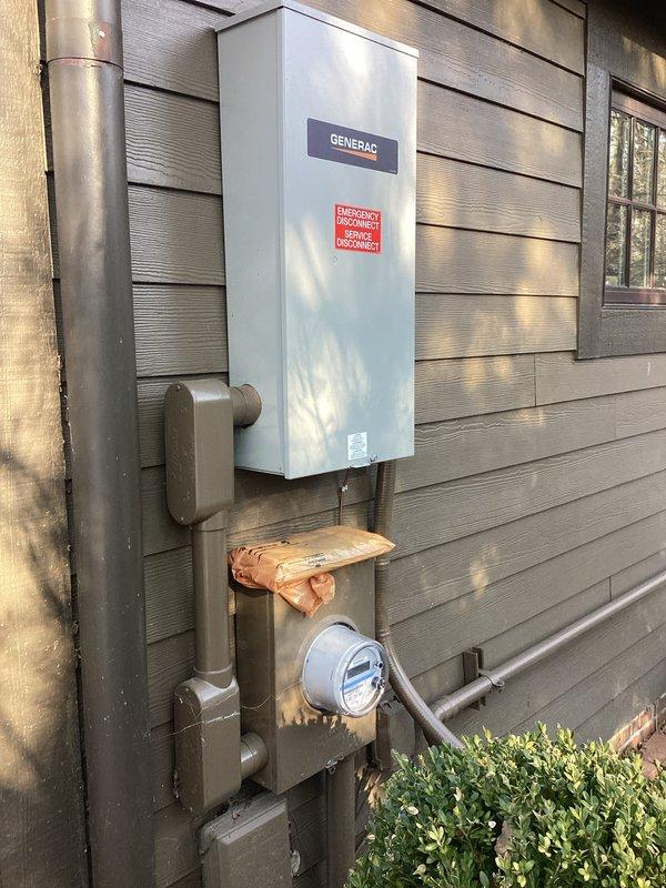 Inspected master bathroom outlets following electrical inspection failure. Performed diagnostic assessment of circuit breaker panel and confirmed proper functionality of panel components. Documented Generac transfer switch installation and existing plumbing infrastructure for reference, but found no electrical issues at the panel that would explain the non-functioning bathroom outlets.