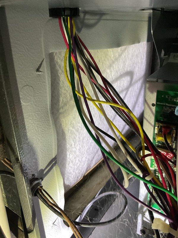 Completed first-year heating system maintenance inspection. Examined wiring connections at control board and terminal block, confirming proper wire routing and secure connections. Inspected ductwork integrity, including main trunk line and elbow joints, with particular attention to seams and connection points. All components appear properly installed with no visible issues.