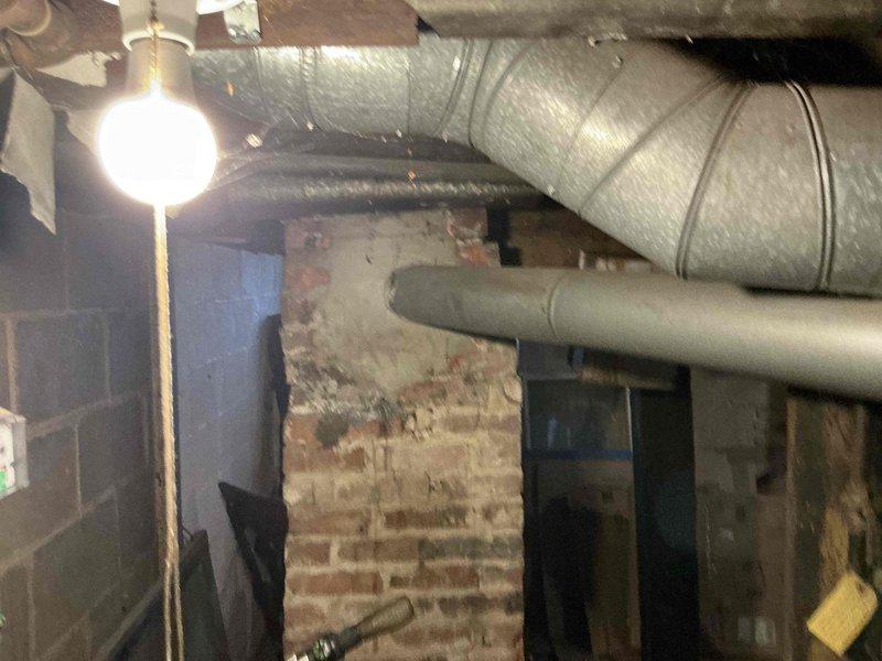 Conducted assessment of 40-year-old furnace system for potential replacement options. Documented existing HVAC configuration, including circular insulated main duct and straight secondary duct mounted in basement with exposed brick and cinder block walls. Created detailed dimensional diagram for proper sizing of replacement equipment.