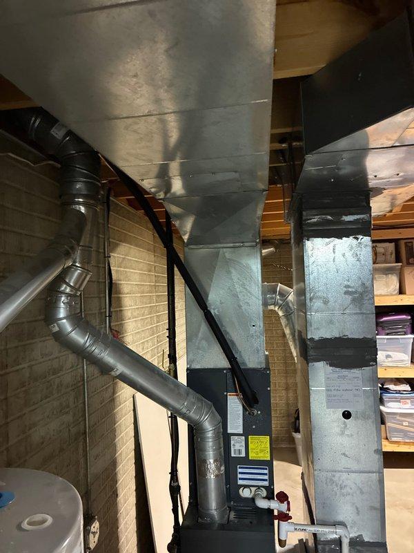Conducted comprehensive evaluation of existing HVAC system in basement for potential replacement, including assessment of current furnace unit and hot water tank. Documented current installation configuration including ductwork condition, connections, and existing equipment placement to develop accurate replacement options that would integrate with the home's established distribution system.