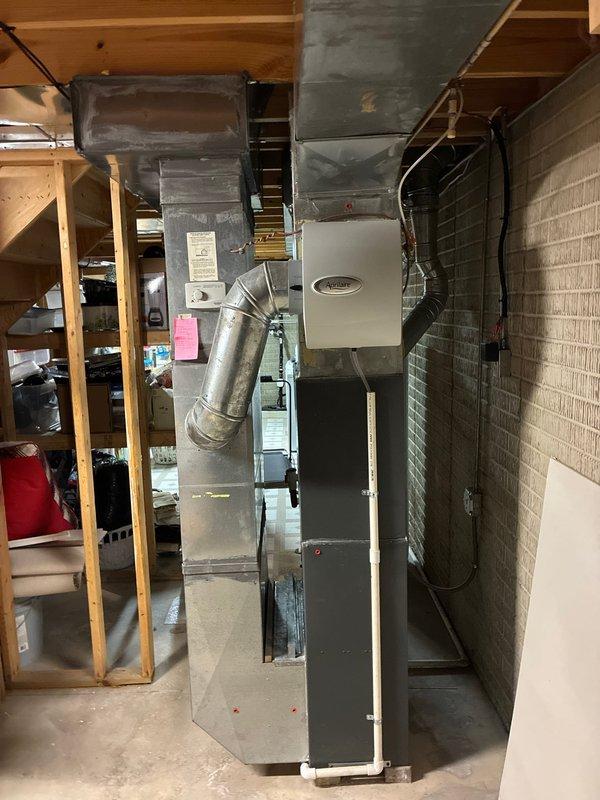 Conducted comprehensive evaluation of existing HVAC system in basement for potential replacement, including assessment of current furnace unit and hot water tank. Documented current installation configuration including ductwork condition, connections, and existing equipment placement to develop accurate replacement options that would integrate with the home's established distribution system.