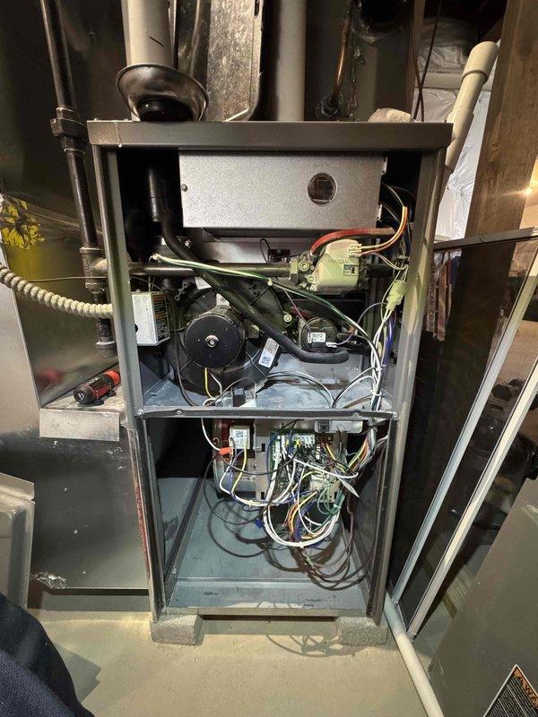Performed scheduled heating maintenance on residential furnace system. Conducted thorough inspection of internal components including fan motor, circuit boards, and wiring harnesses to ensure proper operation. Also examined exterior Lennox AC condensing unit and electrical connections as part of comprehensive HVAC system evaluation.
