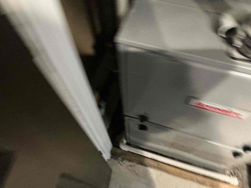 Conducted evaluation of furnace experiencing intermittent operational issues. Inspected the existing white HVAC unit installed in utility area, noting visible wear at base. Examined gas connection system, including yellow flexible gas line with shut-off valve and brass fittings connected to metal piping. Presented replacement options to address ongoing reliability concerns.