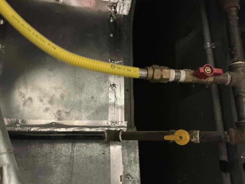 Conducted evaluation of furnace experiencing intermittent operational issues. Inspected the existing white HVAC unit installed in utility area, noting visible wear at base. Examined gas connection system, including yellow flexible gas line with shut-off valve and brass fittings connected to metal piping. Presented replacement options to address ongoing reliability concerns.