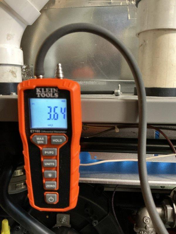 Performed routine heating system maintenance including electrical component inspection and static pressure testing. Circuit board connections were verified intact with no loose wires, and system pressure readings were measured at 36.4 (within normal operating parameters) using Klein Tools digital manometer.