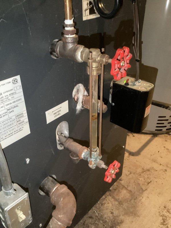 Completed replacement of sight glass kit due to protective rods being rusted in place, preventing removal of original glass. Re-piped Hartford loop which exhibited significant rust buildup and active leakage, as documented in service photos.