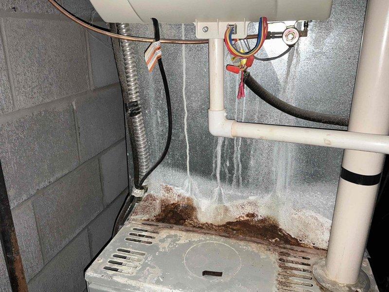 Conducted comprehensive HVAC system replacement consultation, presenting three Goodman equipment options ranging from 13.4-16 SEER cooling efficiency and 80-96% AFUE heating efficiency. Documented existing plumbing configuration and identified significant water damage/mineral buildup near the utility area that will need addressing during installation.