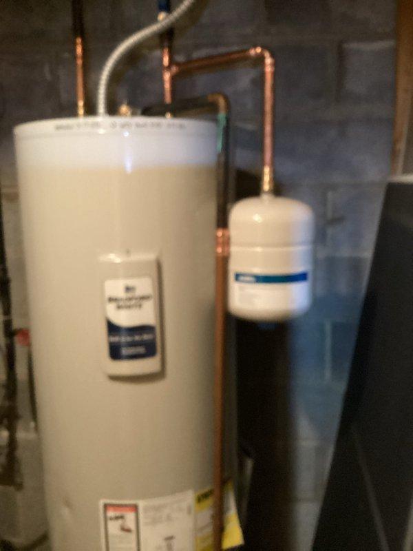 Completed installation of surge protector, air scrubber UV bulb, and expansion tank on existing water heater system. Properly connected expansion tank to water supply line with new copper piping and mounted electronic air purification device to improve indoor air quality. All components tested and functioning as designed.