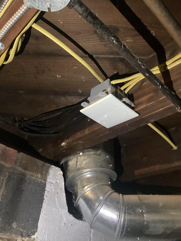 Completed inspection of residential property for complete rewiring estimate. Examined exposed wiring in basement/crawlspace which showed outdated electrical system with junction boxes and exposed cables running alongside joists. Evaluated main electrical panel which contained approximately 24-28 circuit breakers with handwritten labels, indicating need for comprehensive electrical system upgrade to meet current code requirements.