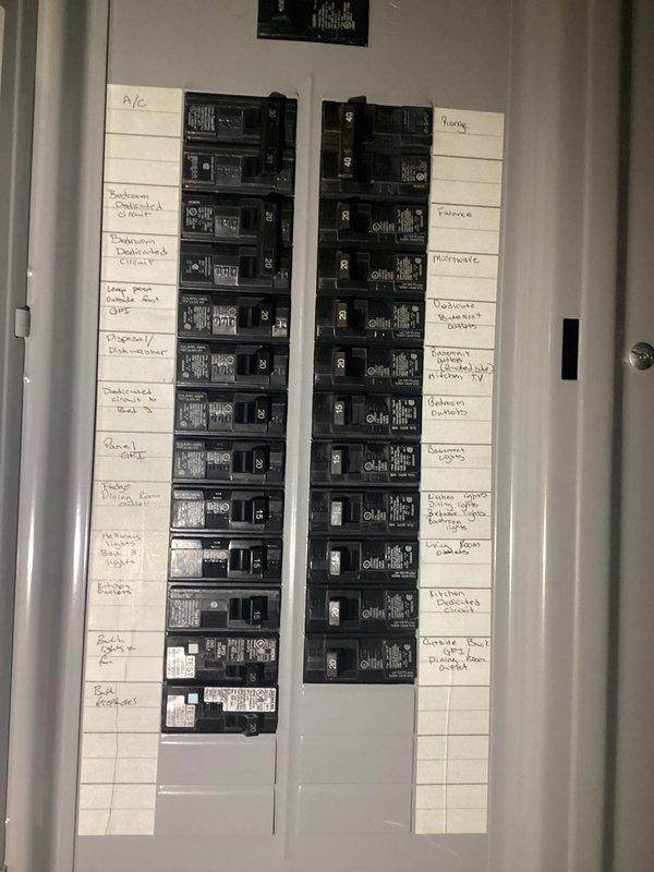 Completed inspection of residential property for complete rewiring estimate. Examined exposed wiring in basement/crawlspace which showed outdated electrical system with junction boxes and exposed cables running alongside joists. Evaluated main electrical panel which contained approximately 24-28 circuit breakers with handwritten labels, indicating need for comprehensive electrical system upgrade to meet current code requirements.