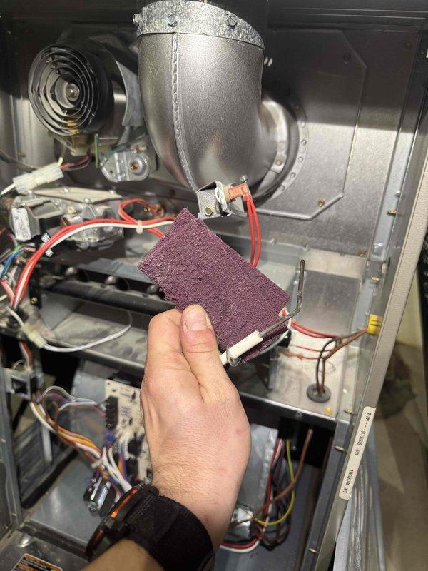 Performed routine heating maintenance on furnace system. Cleaned interior components with abrasive pad, focusing on blower housing and fan assembly. Inspected ductwork, ventilation piping, and electrical connections in utility area; all components functioning properly with no issues identified.