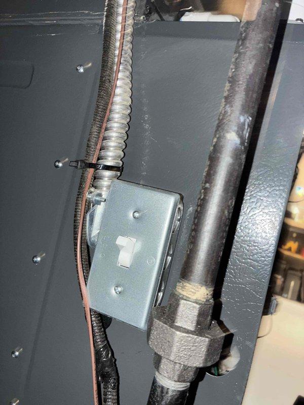 Performed scheduled heating maintenance service on furnace system. Inspected electrical connections including toggle switch, conduit, and internal wiring harness. Examined heat exchanger, pressure switches, and gas valve assembly - all components found to be in proper working condition.