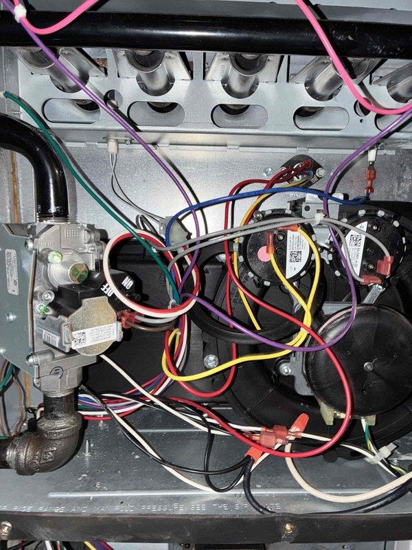 Performed scheduled heating maintenance service on furnace system. Inspected electrical connections including toggle switch, conduit, and internal wiring harness. Examined heat exchanger, pressure switches, and gas valve assembly - all components found to be in proper working condition.