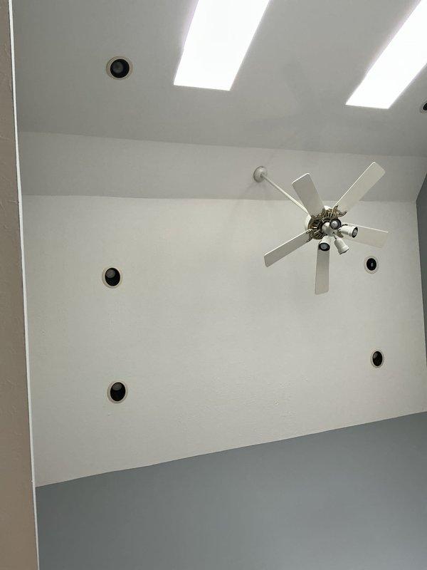 Performed electrical inspection of residential ceiling fixtures including fan installation and recessed lighting. Verified proper mounting of ceiling fan on vaulted surface and examined functionality of integrated light fixtures. No electrical issues identified with the installation.