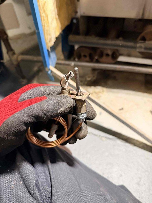 Performed scheduled boiler tune-up, removing and inspecting thermocouple assembly which showed signs of wear. Identified blockage in boiler drain requiring service; documented condition with photos and prepared updated estimate for drain clearing as previous recommendation had been made.