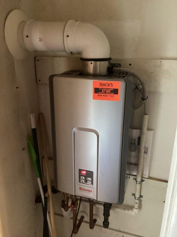 Performed routine maintenance on Rinnai tankless water heater, including cleaning debris from intake vent filter to ensure proper airflow and optimal operation. Inspected all connections and confirmed unit was functioning correctly with temperature set at 118°F.