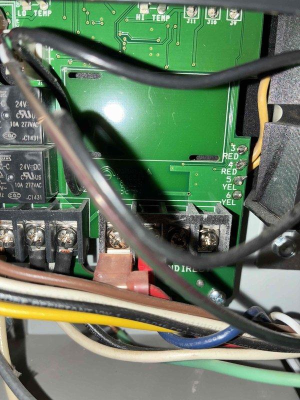 Responded to no-heat service call on boiler system. Inspected control panel displaying 199°F boiler temperature with functional status indicators. Verified proper operation of LWCO safety system and terminal connections on the main control board, confirming all wiring was secure and the boiler was operating normally after service.