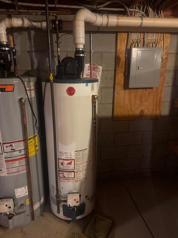 Responded to service call for TNP valve leak on a 2011 Bradford water heater with insufficient heating performance. Inspected dual-tank system in basement utility area, where the primary tank was struggling to maintain adequate water temperature. Replaced faulty temperature and pressure relief valve to resolve leakage issue and restore proper heating functionality.