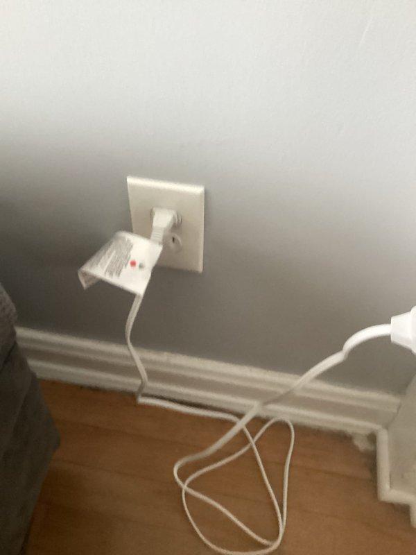 Conducted comprehensive electrical inspection of the property, examining both interior receptacles and exterior meter installation. Verified proper functioning of wall outlets with connected devices and inspected the residential electric meter (ID #5002551602) mounted in weatherproof housing, confirming appropriate wiring connections and conduit installation. Photographic documentation was taken of all inspected components for record purposes.