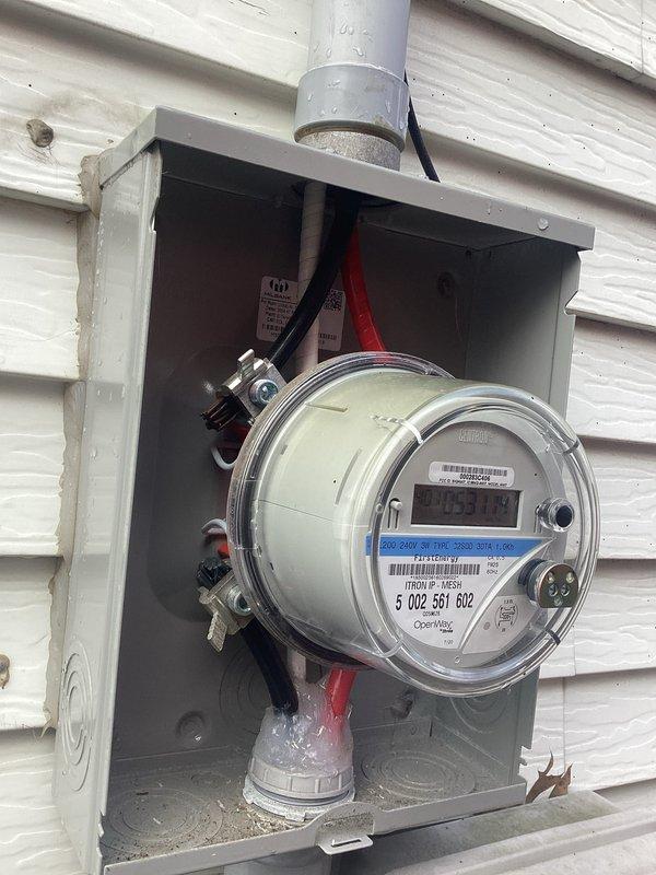 Conducted comprehensive electrical inspection of the property, examining both interior receptacles and exterior meter installation. Verified proper functioning of wall outlets with connected devices and inspected the residential electric meter (ID #5002551602) mounted in weatherproof housing, confirming appropriate wiring connections and conduit installation. Photographic documentation was taken of all inspected components for record purposes.