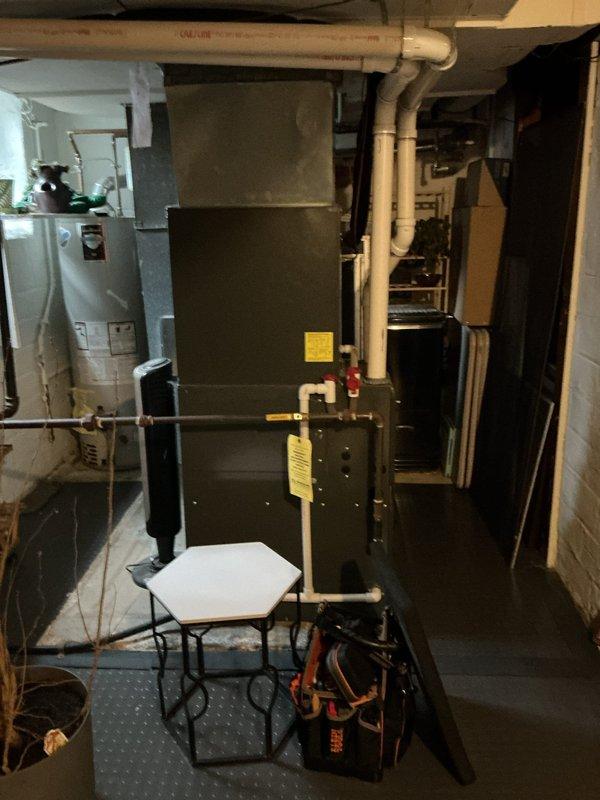 Performed scheduled heating maintenance service on residential furnace system. Conducted full inspection of the heating unit, including examination of ventilation components and PVC exhaust pipes. System was tested for proper operation with no issues detected; all connections secure and functioning normally.