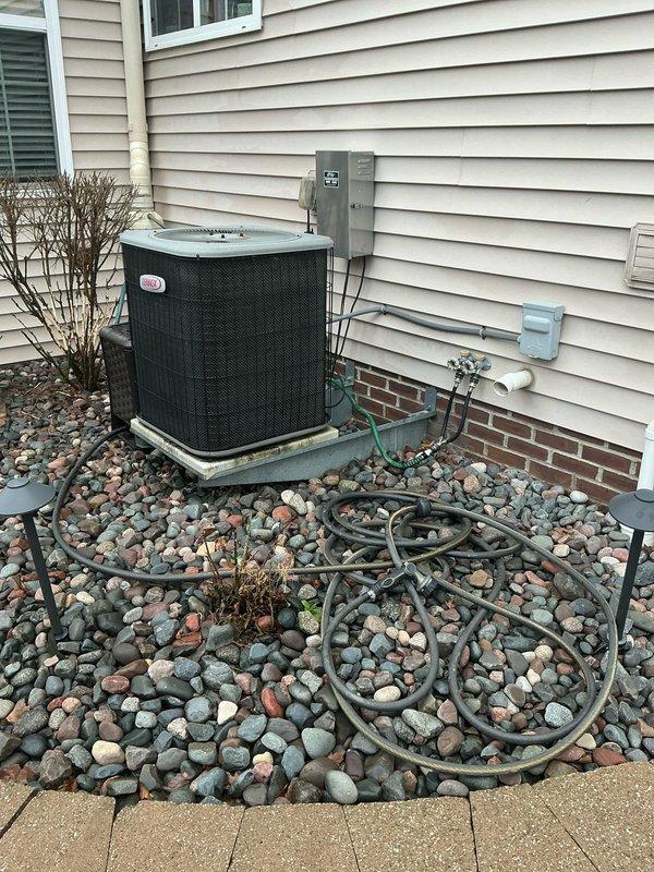 Conducted comprehensive system replacement assessment, including evaluation of existing indoor air handler/furnace with galvanized ductwork and PVC drainage components. Exterior inspection revealed current condenser unit situated on concrete pad with proper electrical disconnect and refrigerant line configuration. Prepared detailed options for complete HVAC system replacement and additional quote for new garage heating installation where no previous unit exists.