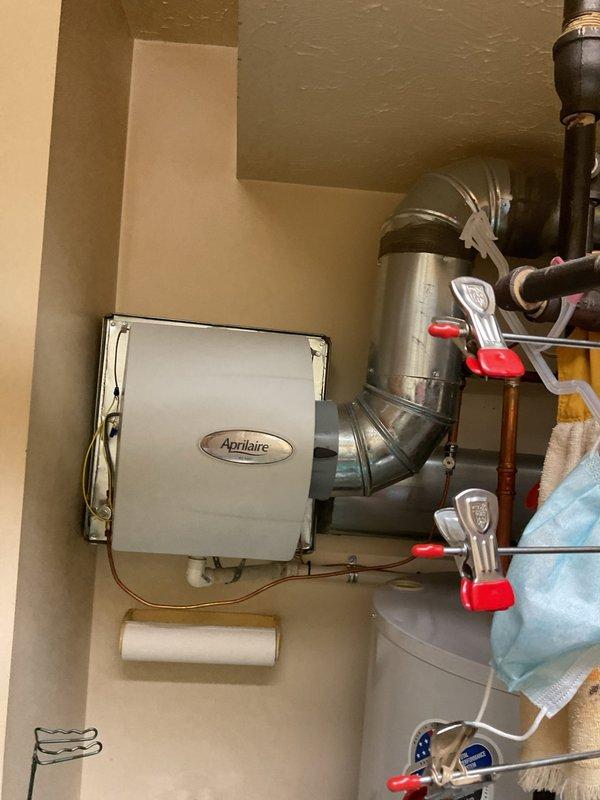 Performed scheduled heating maintenance service on residential HVAC system. Inspected Aprilaire humidifier unit, verified proper connection to ductwork, and checked all associated water supply lines and shut-off valves for proper operation. Examined furnace with digital control system displaying code "301", inspected ventilation network including PVC intake/exhaust piping, and confirmed all components were functioning within normal parameters.