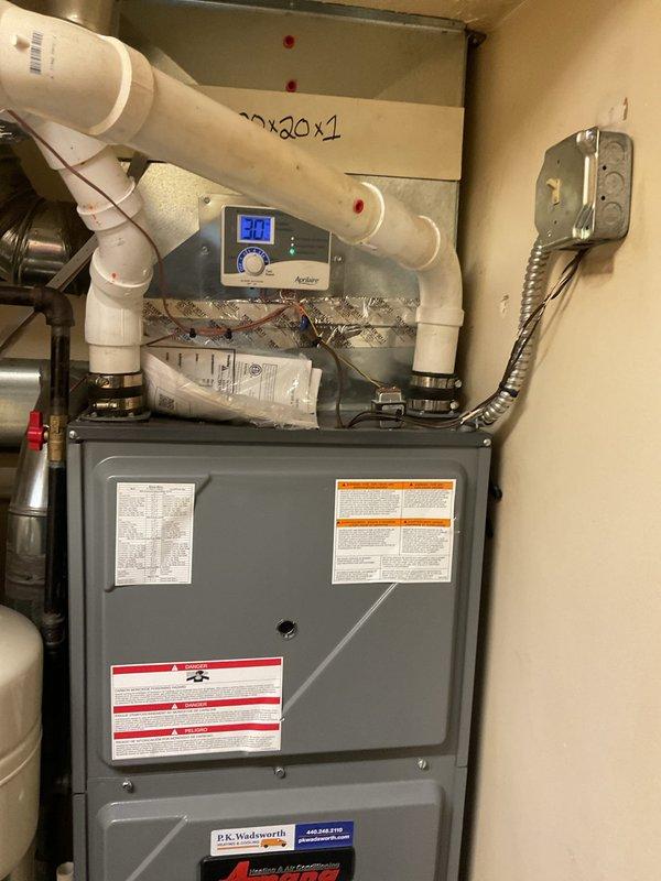 Performed scheduled heating maintenance service on residential HVAC system. Inspected Aprilaire humidifier unit, verified proper connection to ductwork, and checked all associated water supply lines and shut-off valves for proper operation. Examined furnace with digital control system displaying code "301", inspected ventilation network including PVC intake/exhaust piping, and confirmed all components were functioning within normal parameters.