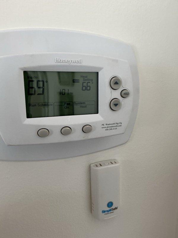 Successfully installed and configured a Honeywell T6 thermostat, replacing the previous unit. System is now operational with heat set to 66°F and displaying proper temperature readings of 69°F. Verified compatibility with existing HVAC system including the Bradford White water heater.