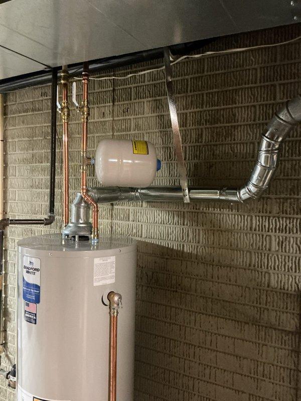 Successfully installed and configured a Honeywell T6 thermostat, replacing the previous unit. System is now operational with heat set to 66°F and displaying proper temperature readings of 69°F. Verified compatibility with existing HVAC system including the Bradford White water heater.