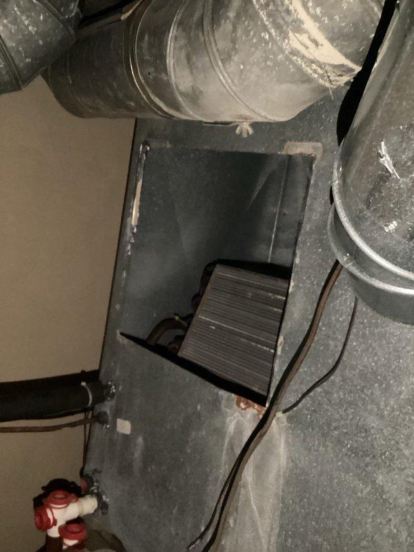 Responded to emergency call for burst pipe leaking into a closet area that was originally planned as a bathroom but never completed. Identified corroded copper T-fitting and straight pipe section with significant oxidation and verdigris formation at the joints as the source of the leak. Removed damaged components and replaced with new fittings, restoring proper function to the plumbing system and preventing further water damage to the property.