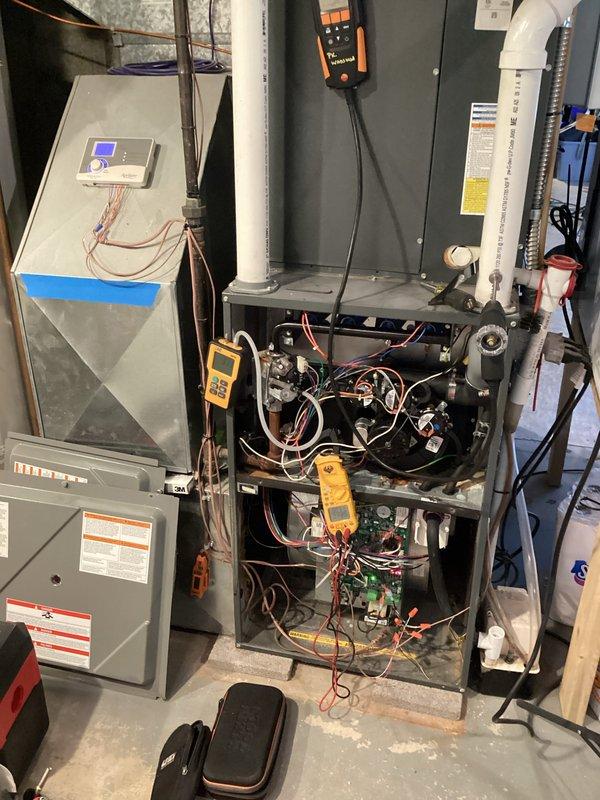 Performed routine heating maintenance on dual system setup. Inspected furnace interior components including circuit board, wiring harness, and blower motor assembly. Conducted diagnostic testing with multimeter and manometer, noting minor oxidation on lower metal surfaces but confirming all electrical connections and pressure switches functioning properly.