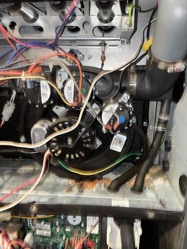 Performed routine heating maintenance on dual system setup. Inspected furnace interior components including circuit board, wiring harness, and blower motor assembly. Conducted diagnostic testing with multimeter and manometer, noting minor oxidation on lower metal surfaces but confirming all electrical connections and pressure switches functioning properly.