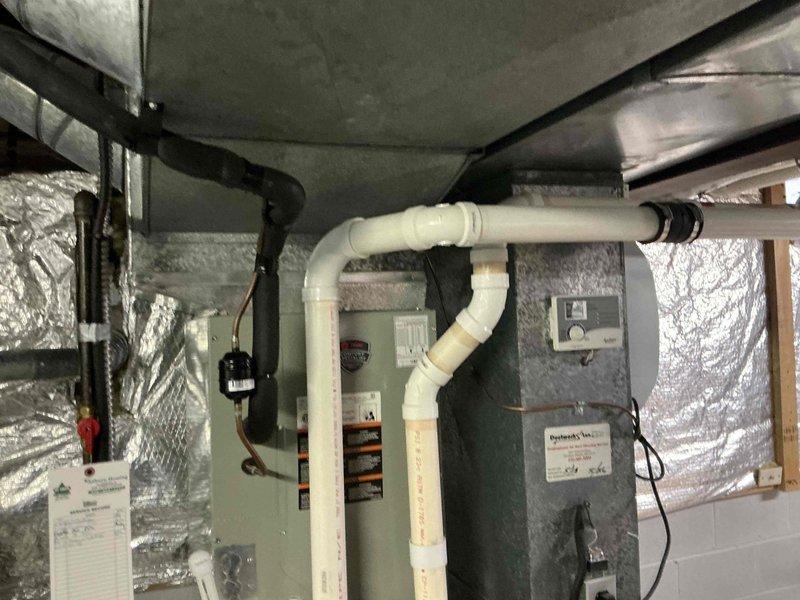 Performed comprehensive assessment of existing HVAC system in basement for potential replacement options. Evaluated current installation which includes furnace with PVC exhaust ventilation, associated ductwork, and control interfaces. Documented condition of equipment, noting proper insulation and connection requirements for replacement recommendations.