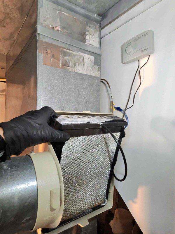 Performed scheduled heating maintenance service on residential furnace system. Inspected and replaced air filter which showed significant dust accumulation. Examined water filtration system including pressure tanks, valves, and related components - all functioning properly.