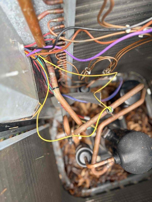 Diagnosed communication failure between thermostat and Goodman heat pump resulting in no heat operation. Inspected outdoor unit and found accumulated debris in coil assembly affecting performance. Cleaned debris from system components and restored proper communication between thermostat and heat pump, returning heating functionality to normal operation.