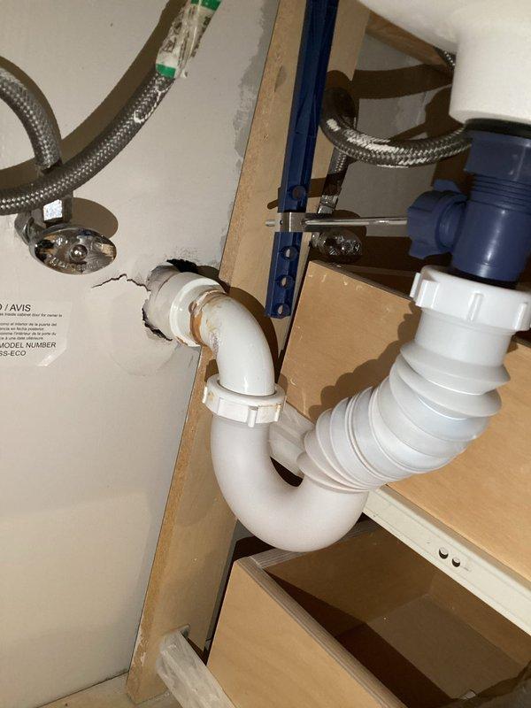 Conducted comprehensive plumbing inspection of bathroom fixtures, examining toilet tank components and under-sink plumbing assembly. Noted mineral buildup and staining in Kohler toilet tank with functioning but aged float ball mechanism and flush valve assembly. Verified integrity of sink's PVC P-trap and braided supply lines with no signs of leakage or deterioration.