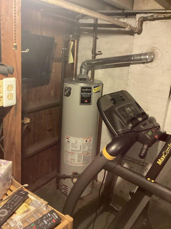 Responded to a service call for a water heater leak. Upon inspection, identified a 20-year-old Bradford White "Defender" tank with significant bottom leakage. Diagnosed terminal failure requiring full replacement. Provided customer with replacement options and documented current installation configuration with photos for proper sizing and connection planning.