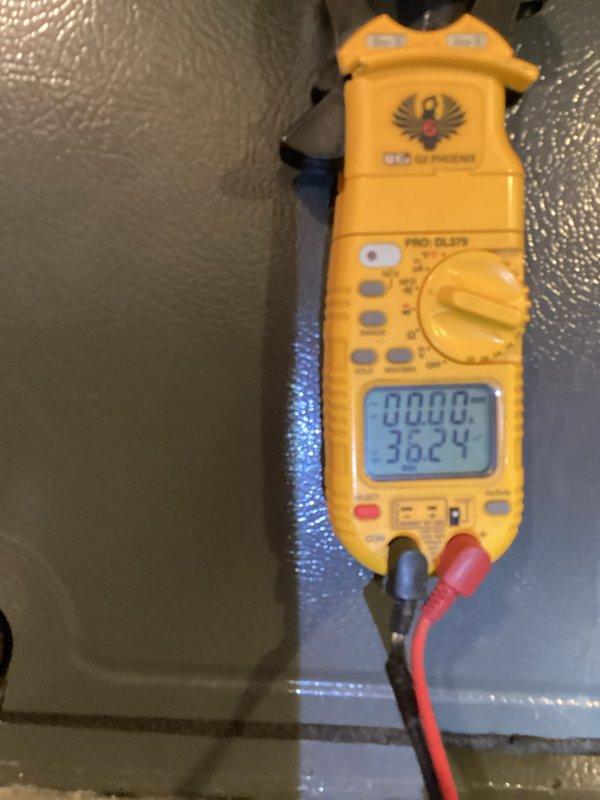 Performed routine heating maintenance service including electrical testing with clamp meter showing normal voltage readings (36.24V) and inspection of blower wheel assembly. Visual examination confirmed proper condition of fan components with no signs of damage or excessive wear.