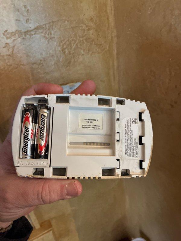 Conducted inspection of thermostat system, noting Energizer AA batteries in place and operational. Examined ductwork connections in mechanical room, identifying galvanized sheet metal ducts with visible joints and seams alongside copper piping. Provided replacement options for furnace system based on observed condition of components.